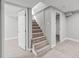 Carpeted stairway connecting floors, flanked by doorways and neutral walls at 3630 Magnolia St, Denver, CO 80207