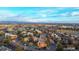 Areal shot of apartments with red roofs and mature trees under a blue sky with mountain views at 14751 E Tennessee Dr # 228, Aurora, CO 80012