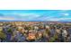 Areal shot of condos with red roofs, lush trees, and ample parking with a scenic mountain backdrop at 14751 E Tennessee Dr # 228, Aurora, CO 80012
