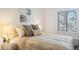 Serene bedroom with comfortable bed, accent pillows, bedside tables, and natural light from a window at 14751 E Tennessee Dr # 228, Aurora, CO 80012