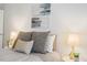 Cozy bedroom featuring a comfortable bed with accent pillows, bedside lamps, and stylish decor at 14751 E Tennessee Dr # 228, Aurora, CO 80012
