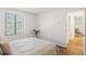 Bright bedroom with natural light, hardwood floors, a side window, and an open doorway to adjacent rooms at 14751 E Tennessee Dr # 228, Aurora, CO 80012