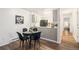 Charming dining area adjacent to the kitchen with black velvet chairs and decor at 14751 E Tennessee Dr # 228, Aurora, CO 80012