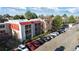 Exterior view of the apartment building with balconies, lush landscaping, and convenient parking, showcasing modern living at 14751 E Tennessee Dr # 228, Aurora, CO 80012