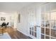Bright hallway leading to an office space with glass French doors and an adjacent dining area at 14751 E Tennessee Dr # 228, Aurora, CO 80012