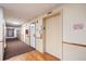 Well-lit hallway with a mix of carpet and faux wood flooring leading to multiple doors and an elevator at 14751 E Tennessee Dr # 228, Aurora, CO 80012