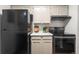 Well-equipped kitchen with black appliances and bright cabinets, perfect for culinary enthusiasts at 14751 E Tennessee Dr # 228, Aurora, CO 80012