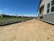 Side view of the exterior showing a large backyard ready for landscaping at 16622 E 109Th Ave, Commerce City, CO 80022