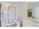 Modern bathroom featuring a glass-enclosed shower, gray marble floors, and a bright white vanity at 16622 E 109Th Ave, Commerce City, CO 80022