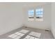 Well-lit bedroom with neutral carpet and two windows providing views of the neighborhood at 16622 E 109Th Ave, Commerce City, CO 80022