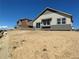 Modern two-story house with gray and beige siding, situated on a lot with partial landscaping at 16622 E 109Th Ave, Commerce City, CO 80022