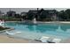Beautiful pool with built-in lounge chairs and a lifeguard stand, offering a relaxing atmosphere at 16622 E 109Th Ave, Commerce City, CO 80022
