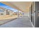 Covered back porch with concrete flooring and sliding glass door at 24709 E 39Th Ave, Aurora, CO 80019