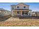 Back of a two-story home with a porch and sliding glass doors overlooking the professionally landscaped yard at 24709 E 39Th Ave, Aurora, CO 80019