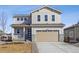 Charming two-story home featuring a two-car garage, neutral siding and a welcoming front porch at 24709 E 39Th Ave, Aurora, CO 80019