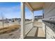 Covered front porch with white columns and railing, stone accents and professional landscaping at 24709 E 39Th Ave, Aurora, CO 80019