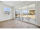 Spacious living room featuring hardwood floors, large windows and sliding glass doors that let in natural light at 24709 E 39Th Ave, Aurora, CO 80019