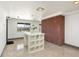 Basement area featuring brick wall, accent lighting and white shelving at 8 Lindenwood Dr, Littleton, CO 80120