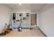 Basement area with shelfing, musical instruments, and neutral carpeting at 8 Lindenwood Dr, Littleton, CO 80120