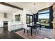 Dining area featuring modern lighting, a large window, and a view of the backyard at 8 Lindenwood Dr, Littleton, CO 80120