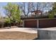 Spacious three-car garage with driveway and basketball hoop, offering ample parking and recreation at 8 Lindenwood Dr, Littleton, CO 80120