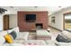 Comfortable living room with a stylish brick fireplace and ample seating at 8 Lindenwood Dr, Littleton, CO 80120