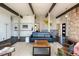 Bright, airy living room boasts dark wood floors, and large windows overlooking outdoor space at 8 Lindenwood Dr, Littleton, CO 80120