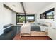 Spacious main bedroom featuring large windows showcasing scenic views and deck access at 8 Lindenwood Dr, Littleton, CO 80120