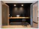 Dedicated office with modern built-in desk and sleek black walls at 8 Lindenwood Dr, Littleton, CO 80120