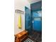Modern tiled shower with glass door, bench, and convenient shelving for toiletries at 8 Lindenwood Dr, Littleton, CO 80120