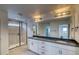 Modern bathroom featuring double sinks, granite countertops, and a glass-enclosed shower at 2197 S Jackson Gap St, Aurora, CO 80018