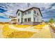 New construction home with stone accents, light siding, and dark trim under a cloudy sky at 2197 S Jackson Gap St, Aurora, CO 80018
