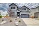 Beautiful two-story home featuring stone accents, gray siding, a two-car garage and a manicured front yard at 2197 S Jackson Gap St, Aurora, CO 80018