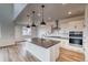 Modern kitchen with stainless steel appliances, subway tile backsplash, and a large island with pendant lighting at 2197 S Jackson Gap St, Aurora, CO 80018
