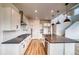 Well-lit kitchen with stainless appliances, stone countertops, and plenty of white cabinet storage at 2197 S Jackson Gap St, Aurora, CO 80018