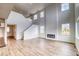 Spacious living room featuring tall ceilings, a modern fireplace, hardwood floors, and a staircase at 2197 S Jackson Gap St, Aurora, CO 80018