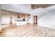 Open-concept layout with views of kitchen, tall ceilings, hardwood floors, and staircase at 2197 S Jackson Gap St, Aurora, CO 80018