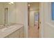 Bathroom features vanity, sink, tile floor, and shower/tub combo with access to the hallway at 1275 Fairfax St, Denver, CO 80220