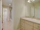 Bathroom features vanity, sink, mirror, tile floor, shower/tub combo, and access to hallway at 1275 Fairfax St, Denver, CO 80220