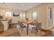 Bright dining room with decorative rug, table and chairs, and wood floors at 1275 Fairfax St, Denver, CO 80220