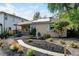 Beautiful front yard with lush landscaping, a brick walkway, and a charming brick home with solar panels at 1275 Fairfax St, Denver, CO 80220