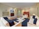 Elegant living room featuring stylish seating, fireplace, piano, and hardwood floors at 1275 Fairfax St, Denver, CO 80220