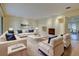 Bright living room features hardwood floors, a fireplace, and stylish white furniture with blue accents at 1275 Fairfax St, Denver, CO 80220