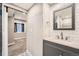Stylish bathroom featuring updated vanity, subway tile, and modern fixtures, adjacent to a carpeted living space at 12362 Nate Cir, Parker, CO 80134