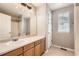Bathroom featuring a vanity with a sink, a large mirror, and a shower/tub combo at 12362 Nate Cir, Parker, CO 80134