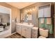 Bathroom with double sink vanity, modern lighting, and a linen closet at 12362 Nate Cir, Parker, CO 80134