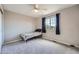 Bedroom with neutral walls, carpet, and a window with navy curtains at 12362 Nate Cir, Parker, CO 80134