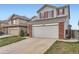 Charming two-story home featuring a large garage and red shutters at 12362 Nate Cir, Parker, CO 80134