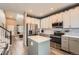Modern kitchen with stainless steel appliances, center island, and wood floors at 12362 Nate Cir, Parker, CO 80134