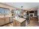 Open-concept kitchen featuring an island, modern appliances, and a view of the dining and living spaces at 12362 Nate Cir, Parker, CO 80134